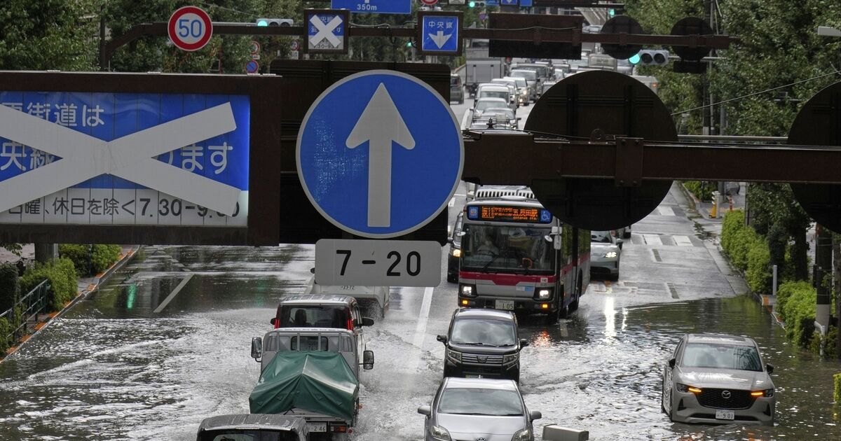 You are currently viewing Heavy rain floods streets and halts air and rail travel in Tokyo – Irish Examiner